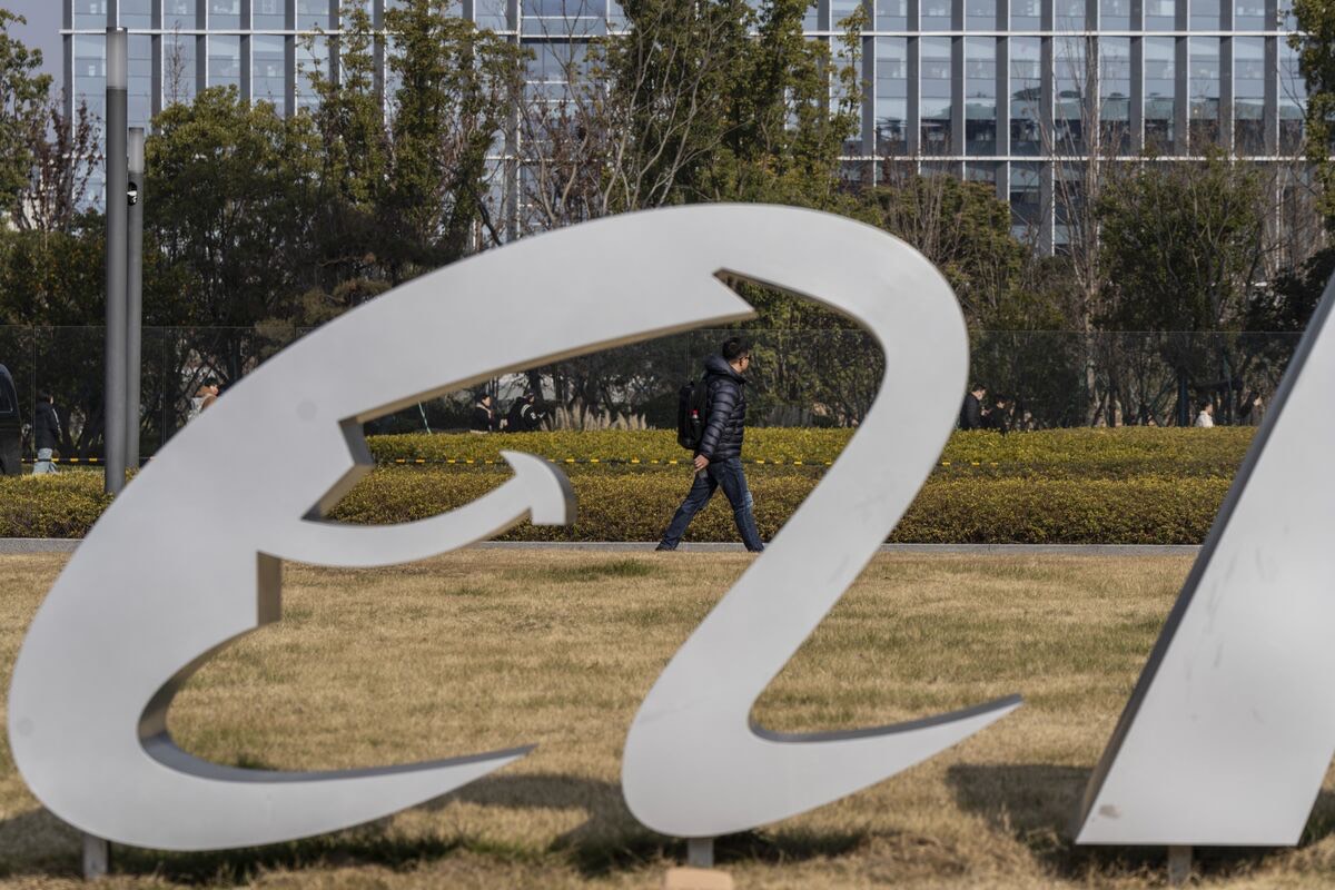 Metal sculpture outside Alibaba’s Hangzhou campus with a pedestrian walking past behind it