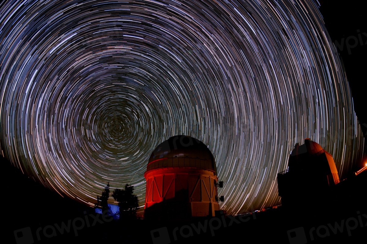 Star trails circling the dome of an observatory in a long exposure