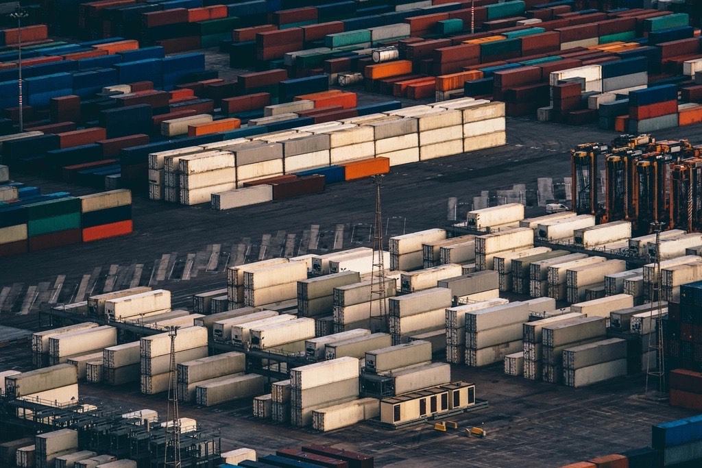 Rows of stacked shipping containers in a port yard