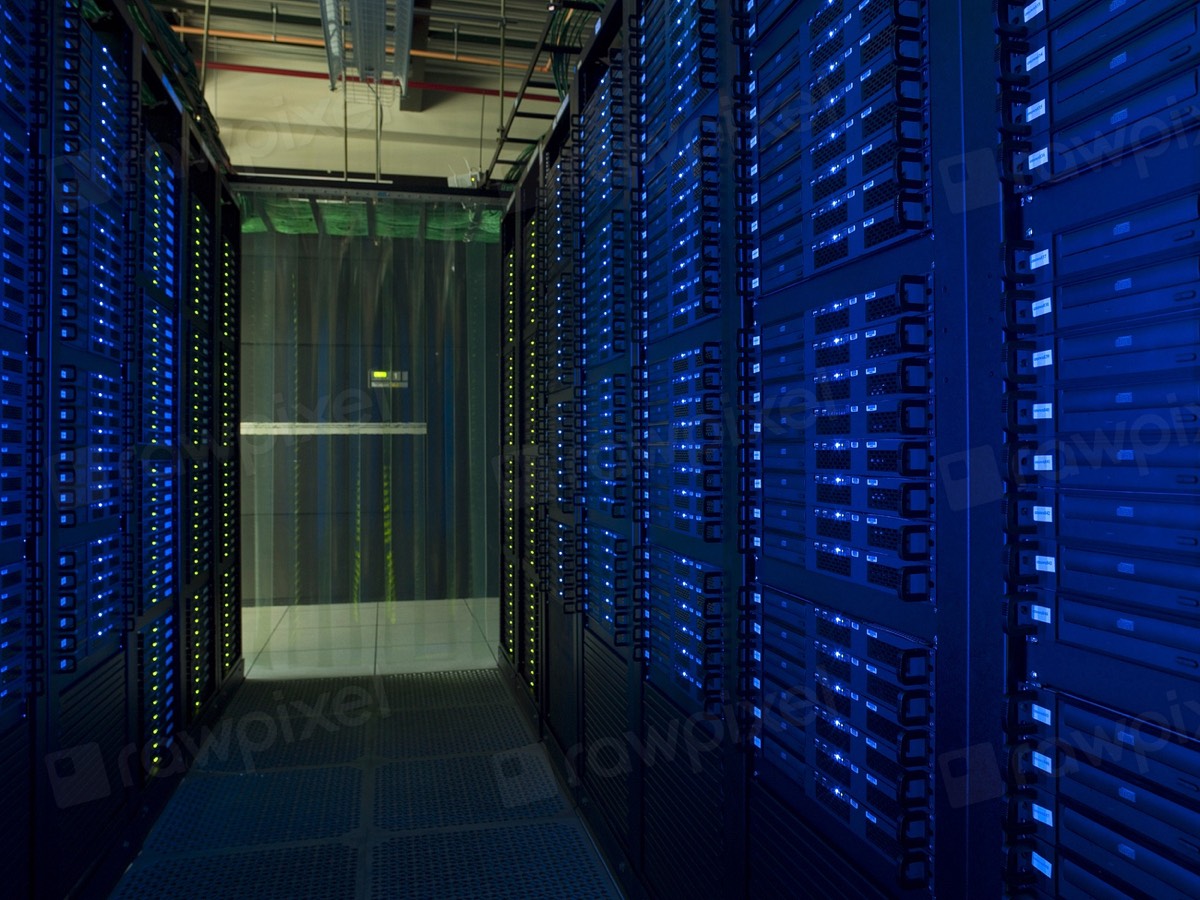 A data center aisle between two rows of racks with blue status lights