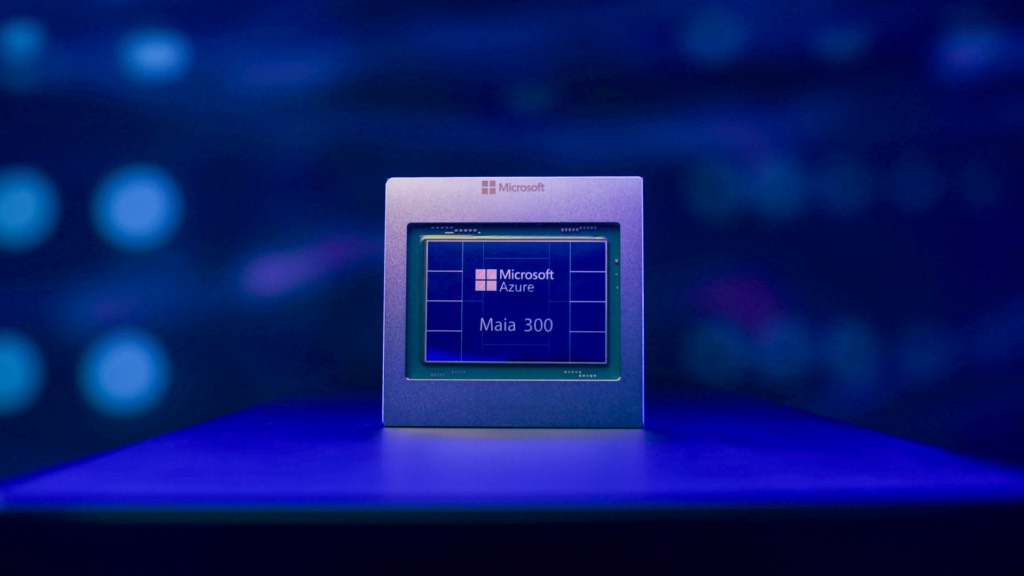 A square Maia 300 accelerator chip module standing on a display surface against a dark blue backdrop