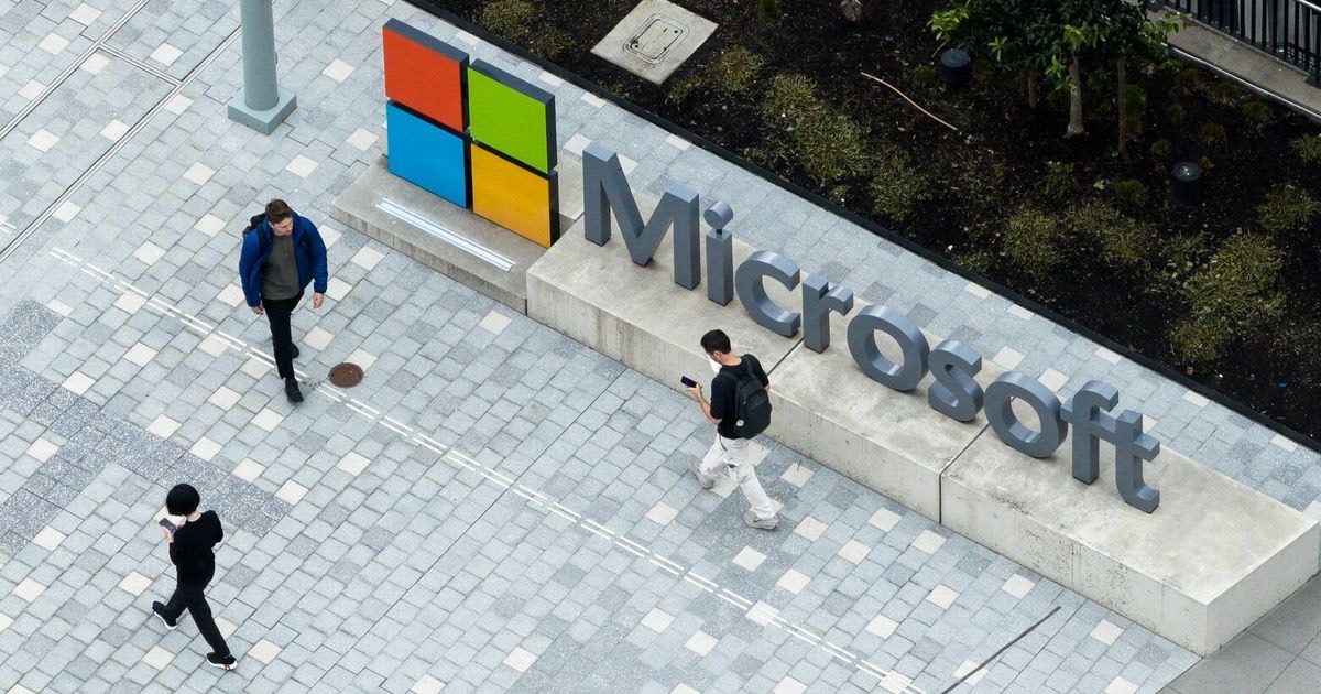 Aerial view of pedestrians walking past the Microsoft sign on the Redmond campus plaza