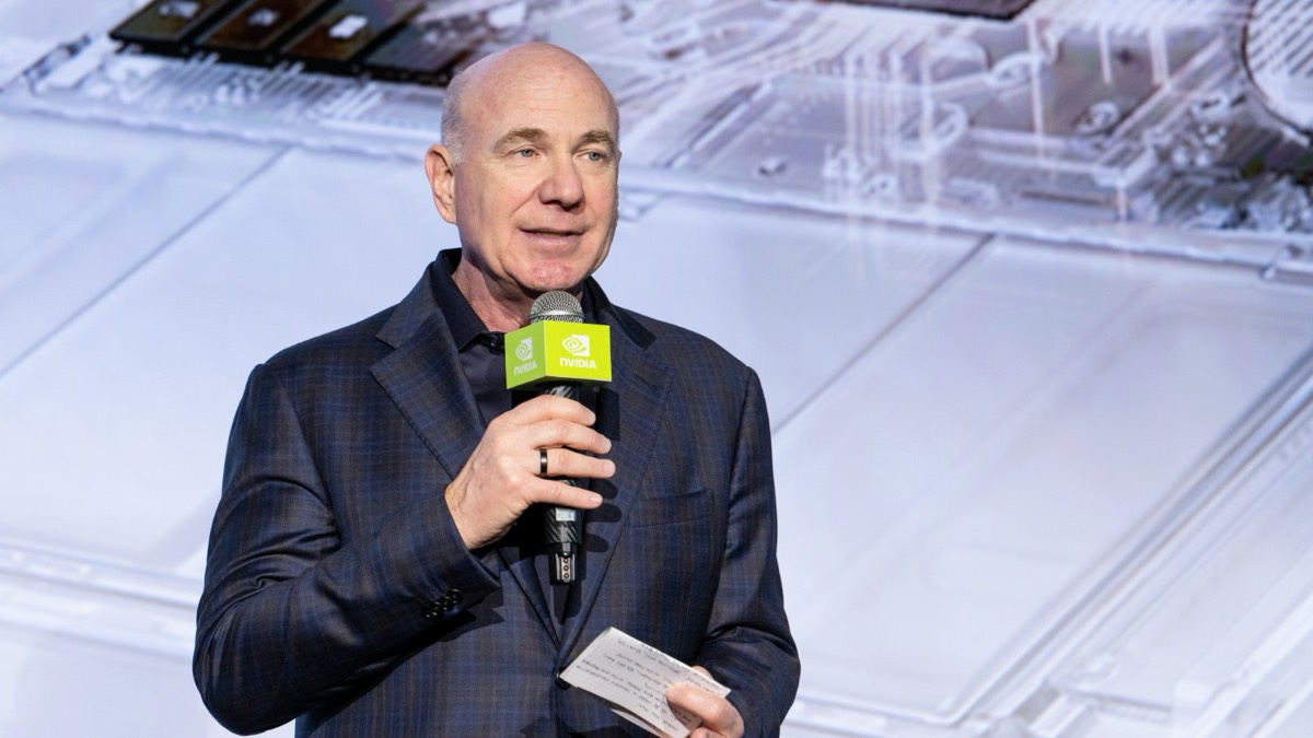Jeff Fisher, Nvidia's senior vice president of personal computing, speaking into a green Nvidia microphone on stage