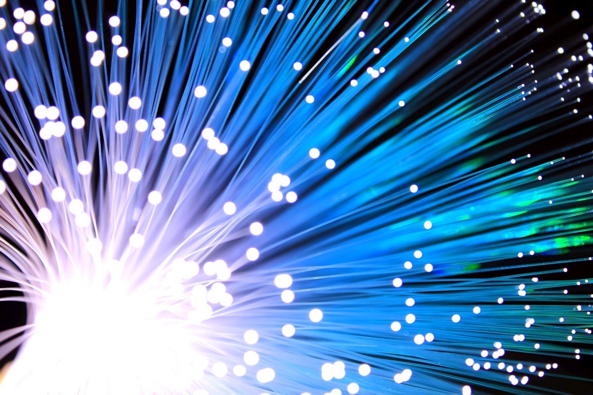 The glowing blue ends of a bundle of optical fibers
